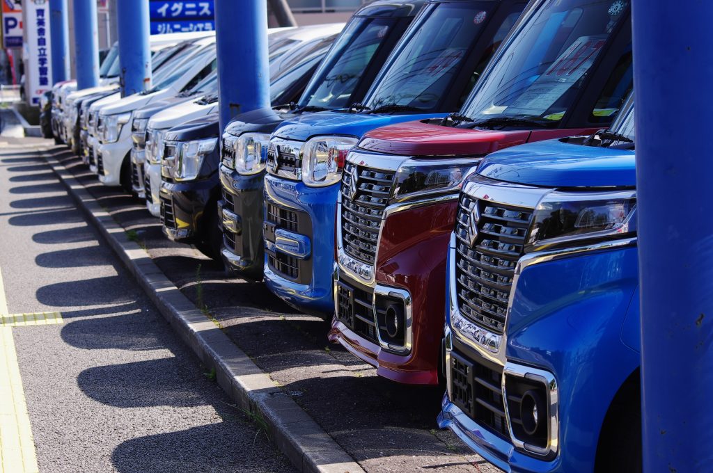 blue and silver cars on parking lot during daytime
