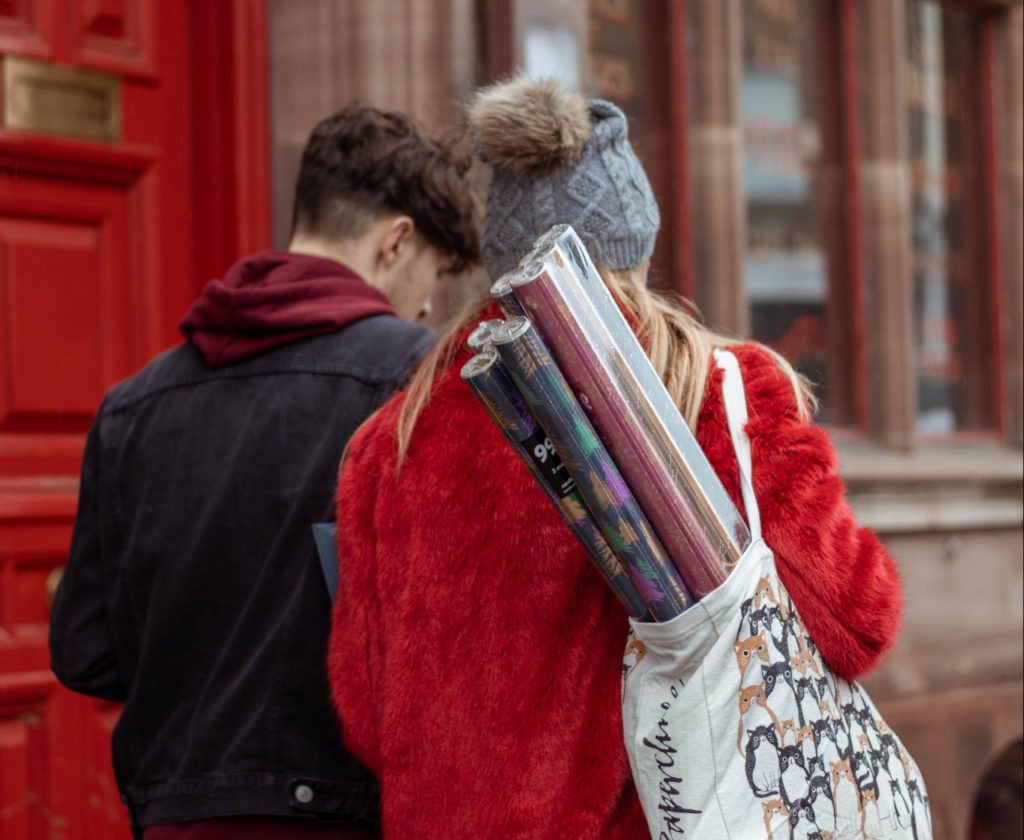 woman in red coat holding book